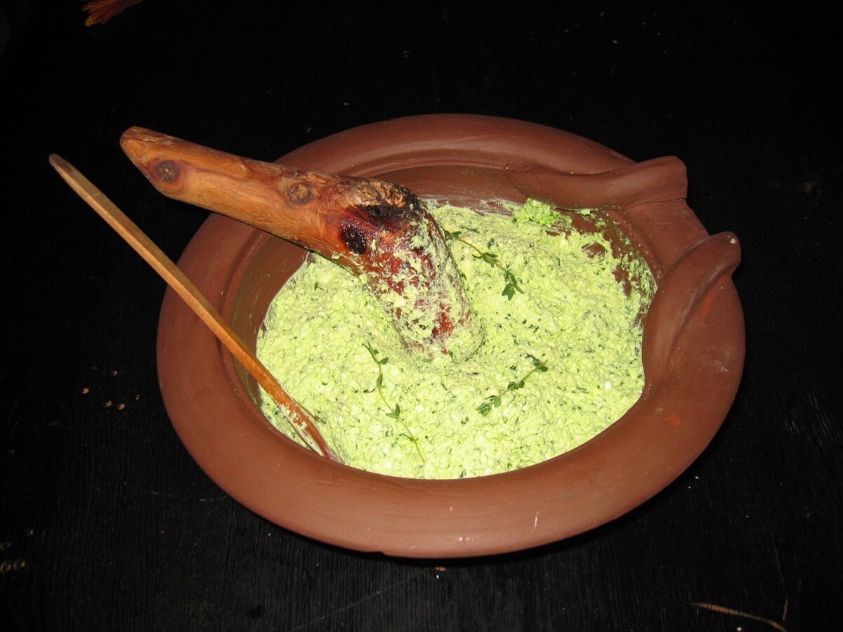 Moretum with a wooden pestle and rosemary twigs as decoration