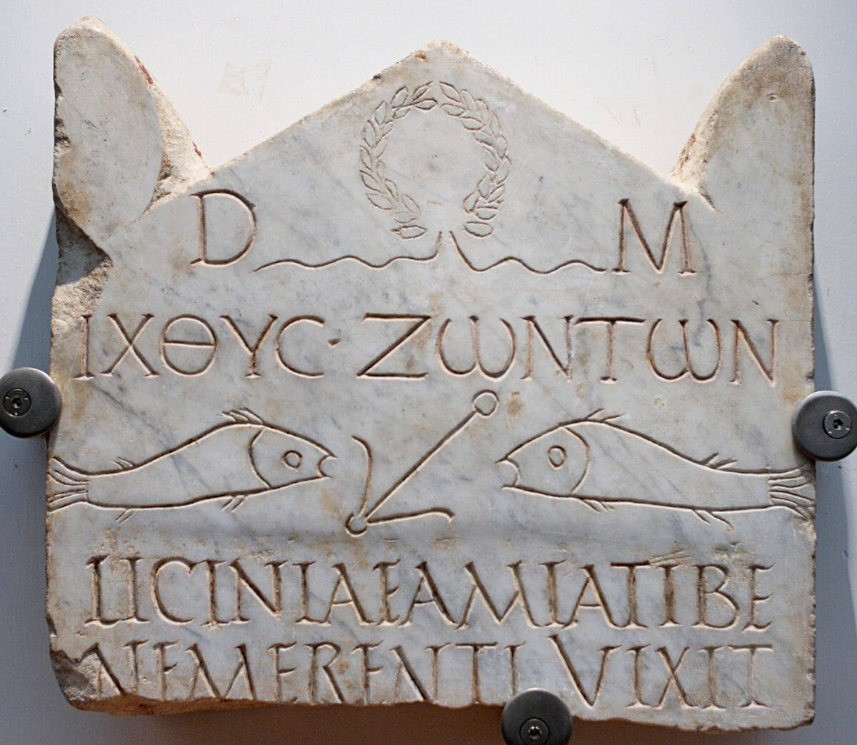 A marble funerary stele from the 3rd century AD, which includes a dedication to the Dis Manibus and Christian motto in Greek letters ΙΧΘΥC ΖΩΝΤΩΝ (fish of the living)